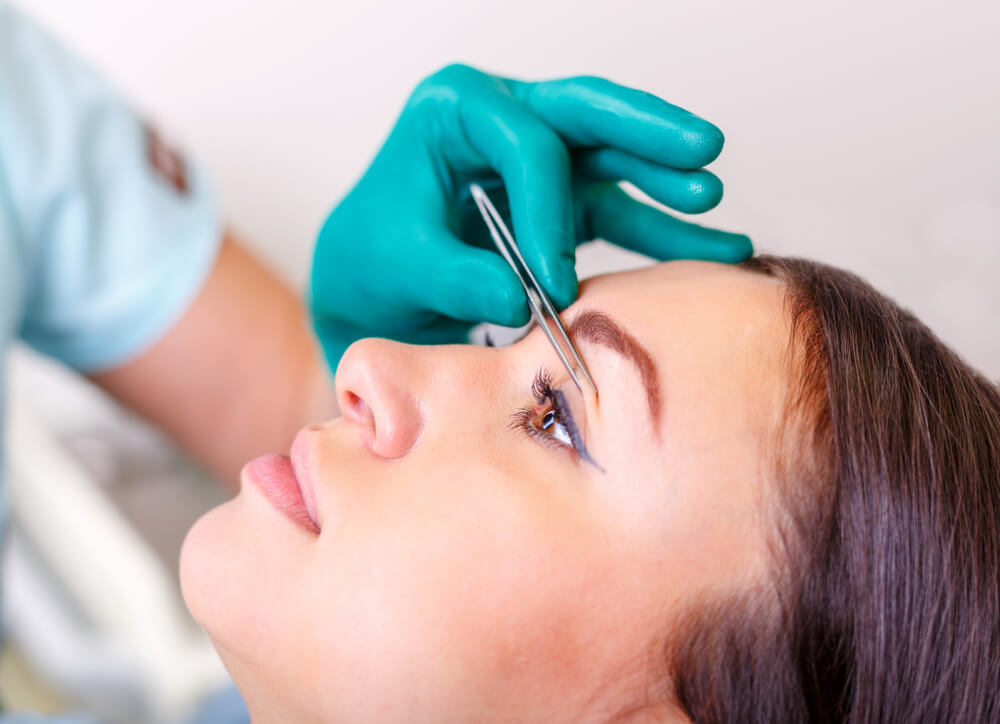 Woman having her eyelid examined by a doctor